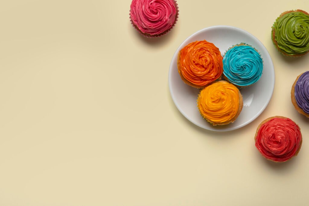 The Psychology of Cakes: Why Cakes Make Every Celebration Special top view delicious rainbow cupcake glaze still life